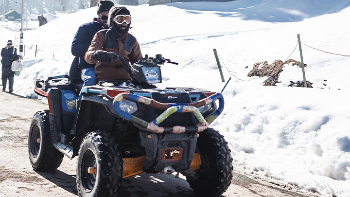 Two people on an ATV in winter